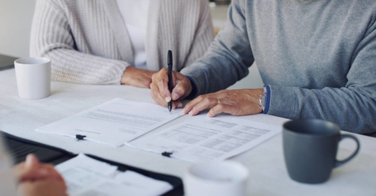 Old couple signing a document